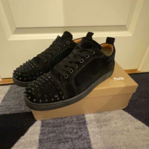 Svarta Christian Louboutin - Snygga Christian Louboutin med nitar.de kommer med skohorn,snören,skokartong,sulan är lite brun/svart som ni ser på bilden men annars inget annat som är fel kan tänka o sänka pris vid snabb affär 