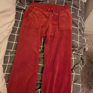Röda juicy byxor  - Snygga röda velourbyxor med märket juuci couture. Säljer för att jag aldrig använder dem. Inget fel på dem utan är i bra skick. Storlek S.