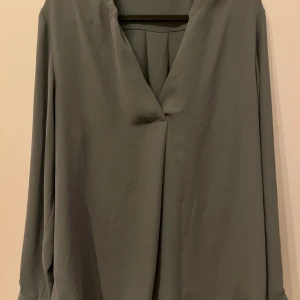 Grå långärmad blus - Den är ungefär ny och har bra kvalité och är väldigt stilig och fin