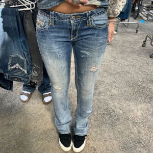 Rock revival jeans  - As snygga slitna jeans från rock revival! Lågmidjade och bootcut och är långa i benen på mig som är 171💕midjemått 43 cm rakt över och innerbenslängd 86 cm