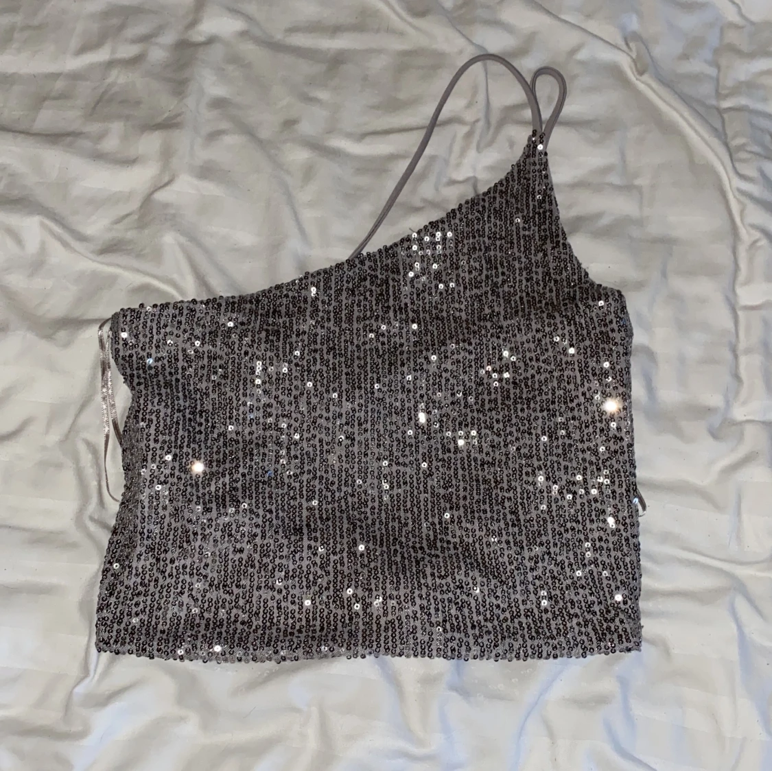 Glittrig oneshoulder topp