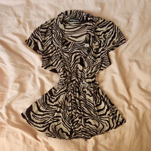 Zebramönstrad blus - Säljer en supercool zebramönstrad blus. Den har korta ärmar och ett snyggt bälte i midjan med glittriga detaljer. Står XXL-XL men jag som är xs passar väldig bra på den (det berör mest som du gillar mest, tycker att det är en L-M)  OBS: ingen bild på! 