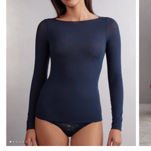 Mörkblå långärmad topp - Säljer en stilren mörkblå långärmad topp i ett mjukt och stretchigt material.  Toppen har en tight passform som framhäver figuren. Använd ett fåtal gånger! Skriv för egna bilder💘