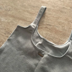 Ljusblått ribbat träningslinne  - Säljer en ljusblå träningstopp från aim’n, med djup rygg. 