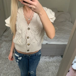 Zara stickad kofta med volang - Säljer denna ärmlösa kofta från Zara. Har du någon fråga är det bara att höra av dig🫶🏻