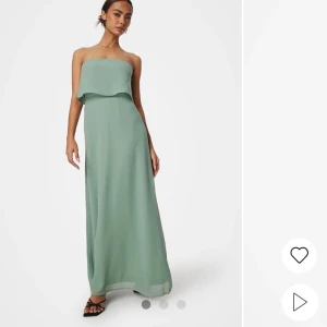 Grön axelbandslös långklänning - Säljer denna snygga klänning, perfekt till bal, helt oanvänd med lappar kvar.