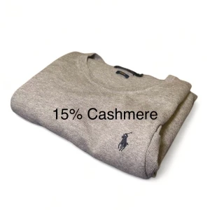 Kashmir-tröja från Polo Ralph Lauren - Säljer en stilren grå finstickad tröja från Polo Ralph Lauren i slim fit. Tröjan är tillverkad av 85% bomull och 15% kashmir, vilket ger en mjuk och lyxig känsla. Den har långa ärmar och en diskret logga på bröstet. Perfekt för en elegant vardagslook. Storleken är M men då den är slimfit så skulle den även kunna passa S. Skicket är väldigt bra, knappt använd