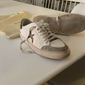 Vita sneakers från Axel Arigato - Säljer ett par vita sneakers från Axel Arigato! Skick 6/10🌟 kommer med en dustbag. Ny pris 2550. Priset går att diskutera då skorna har sina små skavanker!