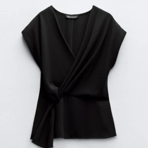 Svart omlottopp från Zara - Snygg svart omlottopp från Zara som är slutsåld. Helt ny med prislapp