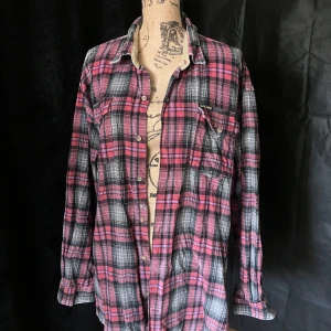 Rutig skjorta från Choice Blue Jeans -  Rutig skjorta från Choice Blue Jeans i rosa och svart. Skjortan är i ett något tjockare material så den funkar bra nu när det är kallt. Storlek XL