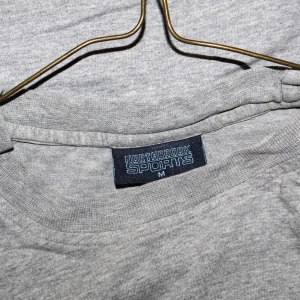 Grå t-shirt från Northbrook Sports - Säljer en klassisk grå t-shirt från Northbrook Sports i storlek M. Perfekt för vardagsbruk eller träning. T-shirten är i bomull och har en normal passform med korta ärmar. Enkelt och stilrent plagg som passar till det mesta.