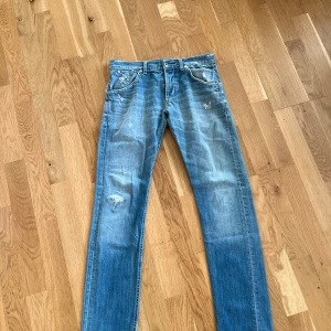 Blå jeans med slitningar - Säljer ett par snygga Dondup jeans i bra skick. Storlek 31. Nypris runt 3000-3500. Vid smidig affär skickar jag även med en parfym