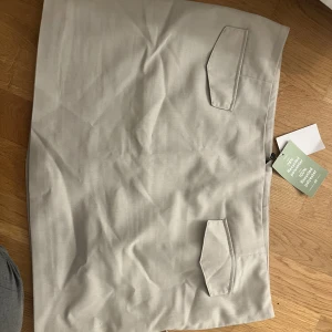 Kostym kjol - Kjol i kostym stil, finns beige och svart. Användes ej längre. Båda är använda två gånger var. Små i storlek så jag gick upp en för att de skulle gå lite längre ned på benen. Spännes i sidan med dragkedja. Erbjuder att sy in dem vid köp ifall det önskas. 