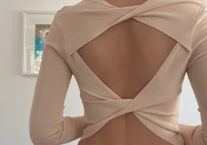 Topp med öppen rygg - Jättefin beige/rosa topp med öppen rygg. Säljer då den inte kommer till användning för mig, aldrig använd.