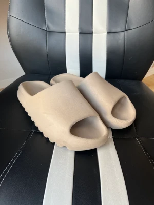 Yeezy Slides - Säljer mina slides då dem är lite för små, cond 7/10. Har box som följer med.