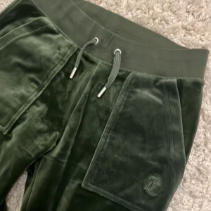 Juicy couture  - Säljer dessa jättefina juicy byxor i färgen dark moss! Säljer pga de inte kommer till användning. Använda väldigt fåtal gånger så inga defekter! Storlek Xs men passar även S. Nypris är 1200 men säljer för 600! KAN SÄLJA BILLIGARE VID SNABBAFFÄR. 