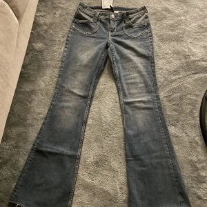 Lågmidjade Jeans  - Jättefina lågmidjade utsvängda  jeans från H&M. Aldrig använt, har fortfarande prislapp kvar då de inte passat mig. 