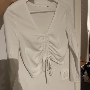En vit långärmad topp - En vit långärmad topp i färgen vit. Säljer den för 50kr plus frakt. Den är i storlek xs