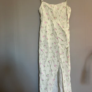 Långklänning - En lång klänning med slits och dragkedja på sidan. Har en del fläckar, därav priset!