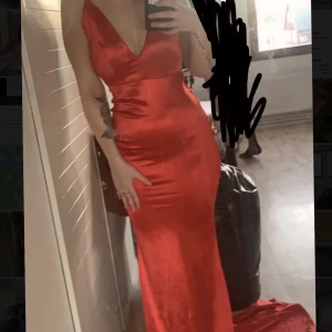 Röd Balklänning  - Bilderna blev väldigt inzoomade så skriv privat om ni vill ha fler bilder! Det är ett lång släpp på klänningen, inga hål, fläckar eller liknande 