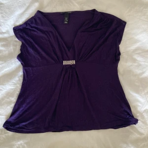 Lila topp - Fin lila topp med lite fina stenar framtill, lite kortare ärmar, väldigt skönt material!💗💗