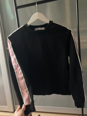 Tröja - En supercool svart tröja med rosa och vita detaljer vid sidan av ärmarna. Jättefin att använda som träningströja ⭐️💗 (Aldrig använd) 