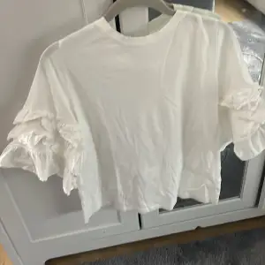 Säljer denna vita t-shirt med volanger på ärmarna ifrån hm,storlek S💓