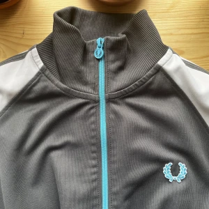 Fred Perry tröja - Fin grå och blå zip up från Fred Perry! Jättefint skick köpt secondhand