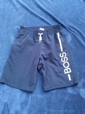 Hugo boss badbyxor  - Hugo boss badbyxor som jag säljer för att de var för små när jag köpte dem. De är i storlek 14/S. De är knappt använda (9,5/10).