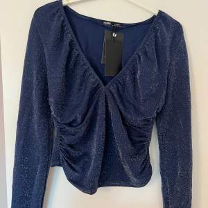Blue top with sparkles, new with tags, super cute for a night out!! Size XL new with tags never worn