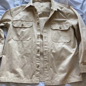 Beige Skjorta - Säljer en fin skjorta på grund av för stor storlek för mig. Den är i helt nyskick, storlek L/XL