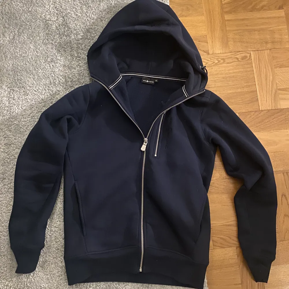 Snygg mörkblå sail racing zip i storlek xs, bra skick och kvalitet, killen på bilden är 170 och tröjan sitter perfekt, passformen är slim fit med lite bredare vid axlarna.. Hoodies.