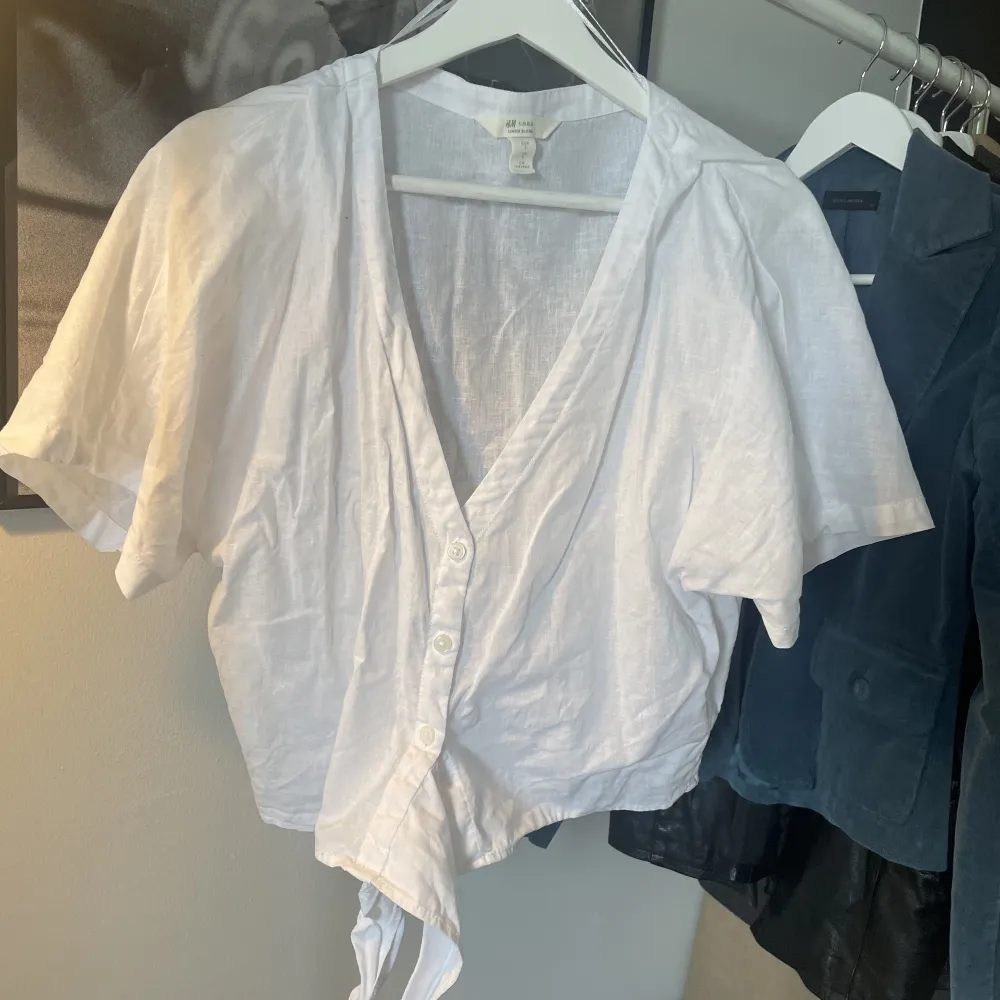 T-shirt/blus i linne material perfekt till sommaren. Har snörning nedtill men den kan även stoppas in vilket man ser på bild två.. Blusar.