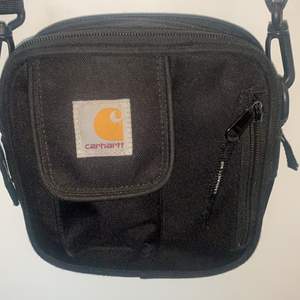 Cute adjustable carhartt bag, fits a lot of things inside. Shipping is not included. Paying with swish:)