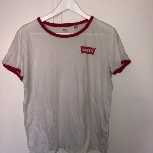 Levis T-shirt strl L - Vit Levis T-shirt med röda detaljer. Använt skick. Strl L