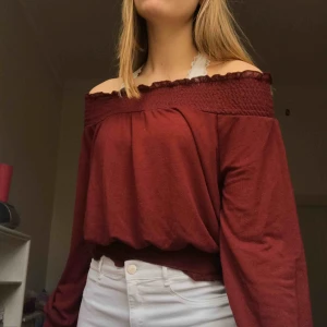  - Maroon-red off the shoulder top from gina tricot. The neckline, bottom of sleeves, and bottom of the top are ruffled and the whole shirt is soft/ stretchy. It says it’s size S but could easily fit M as well💘