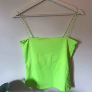  - Ett coolt linne i neongul/grön färg. Använd 2-3 gånger men har mindre slitningar på bröstet. I ett stretchigt och skönt material med tunna axelband. Kan mötas i Göteborg annars står köparen för frakten på 42kr😊⚡️