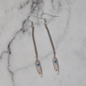  - Fina silverfärgade örhängen med fjädrar. Nickelfria. Fri frakt vid köp över 100:-.