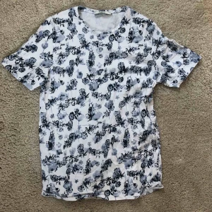  - Skön t-shirt från butiken Jack & Jones. Storlek L, schysst blommigt mönster i ljusblått, mörkblått och vitt 
