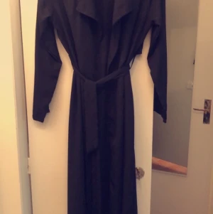 Trenchcoat tunn - Tunn trenchcoat design, lång ner till fötterna finns i Sundbyberg 