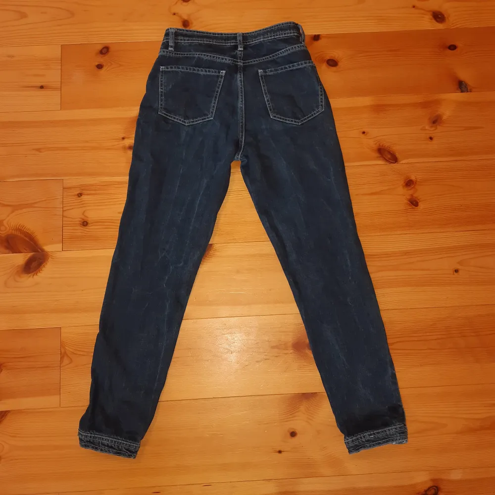 Mörkblå jeans med vita sömmar från NA-KD. De sitter superfint men säljer dem då jag har växt ur dem. De är i jeansmaterial, det vill säga inte stretchigt material. Vi kan antingen mötas upp i hbg eller fraktar jag dem. . Jeans & Byxor.