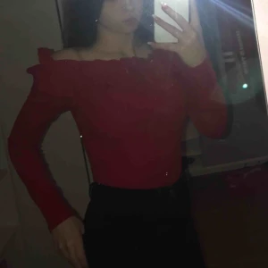  - Röd figursydd of shoulder tröja med volanger uppe. Använd fåtal gånger. Köpt på Nelly, dåligt ljus på första bilden, andra bilden är hur färgen egentligen är