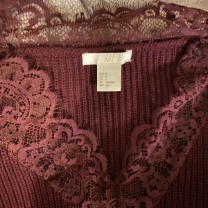 Stickat tröja - Otroligt fin stockat tröja i vinröd, med spets på v-ringningen, passar till allt möjligt. Så himla finni vintern! 