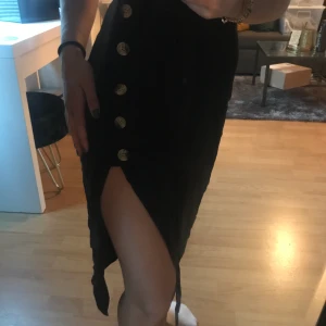 Kjol  - Skön kjol med slits som blir så fint då de är knappar halvvägs som ger kjolen något lite extra!