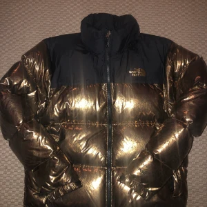 North face guld jacka - Helt oanvänd Dunjacka i guld . Märke The Norh Face . Inköpt 2020. Säljes pga felköp.