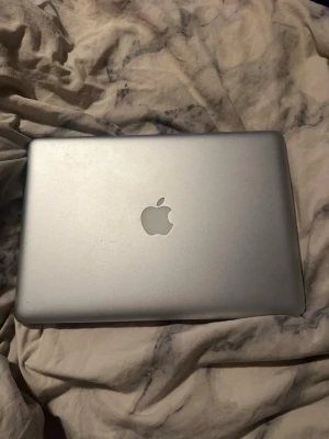 MacBook Pro 13 tum aluminium - Säljer en MacBook Pro med 13-tums skärm i snyggt silverfärgat aluminium. Klassisk Apple-design med bakgrundsbelyst tangentbord och stor touchpad. Perfekt för studier, surf och kreativt arbete. Laddas via MagSafe och har tydlig Retina-skärm.