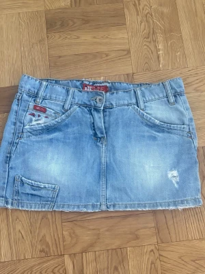 Ljusblå jeanskjol  - Säljer en ljusblå jeanskjol från Inside med slitna detaljer och rå kant nertill. Kjolen har klassiska fem fickor, bälteshällor och knappstängning framtill. Lågmidjad💗 kan diskutera pris!