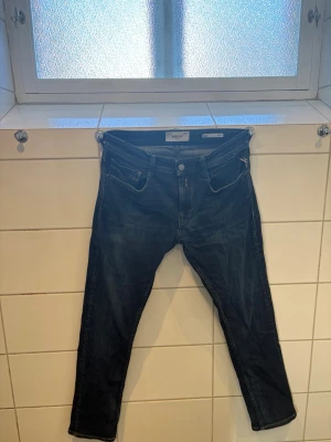 Mörkblå jeans från Replay - Snygga mörkblå jeans från Replay med klassisk femficksmodell och smal passform. Jeansen har en diskret tvättad look och är tillverkade i ett mjukt denimtyg. Storlek- W29 L30