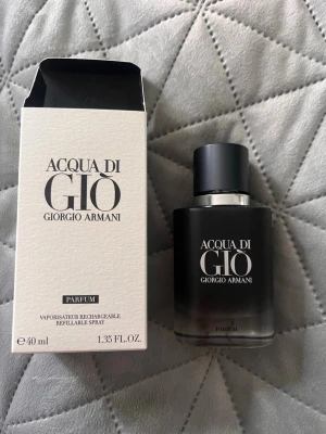 Acqua di Giò Parfum 40 ml herrparfym - Acqua di Giò Parfum från Giorgio Armani i en elegant vit kartong med svart text. Flaskan innehåller 40 ml och är en påfyllningsbar spray. Doften är klassisk och fräsch, perfekt för dig som gillar exklusiva parfymer med stilren design. Ordinariepris ca 1059kr