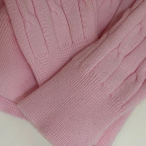 Rosa kabelstickad tröja från Gant - Supersöt ljusrosa kabelstickad tröja från Gant i bomull. Klassisk rund halsringning, långärmad och med broderad Gant-logga på bröstet. Sitter snyggt med en slim passform och passar perfekt till jeans eller kjol. Storlek XS